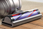 The Dyson Compact Animal upright vacuum cleaner. Self-adjusting cleaner head with carbon fiber filaments for gently removing fine dust from hard floors.